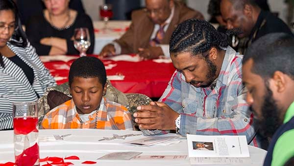 Community members pray before having a meal at the 16th annual Franklin Community Leadership Breakfast. -- Cain Madden | Tidewater News