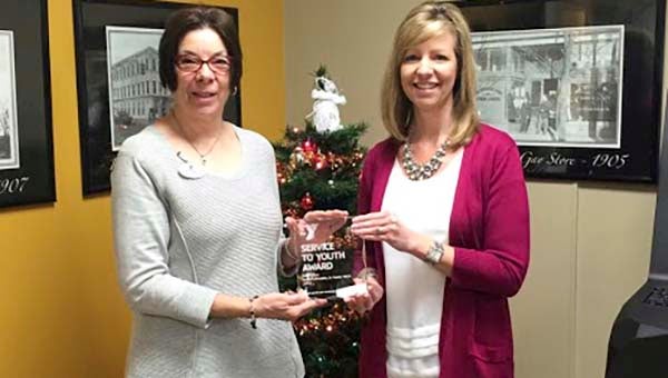 Kathleen Roberts, left, presents the YMCA’s Service to Youth Award to Amy Simms. -- SUBMITTED