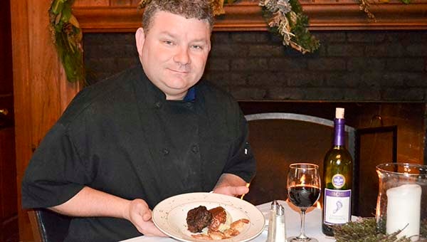 Kyle Cousins, the executive chef at the Cypress Cove Country Club in Franklin, shows off one of his culinary creations served at the restaurant. -- Mitzi Lusk | Tidewater News