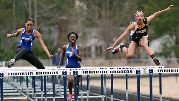 Josie Rankin, far right, jumps a hurdle during the 100. Rankin placed first in the event. -- Frank Davis | Tidewater News