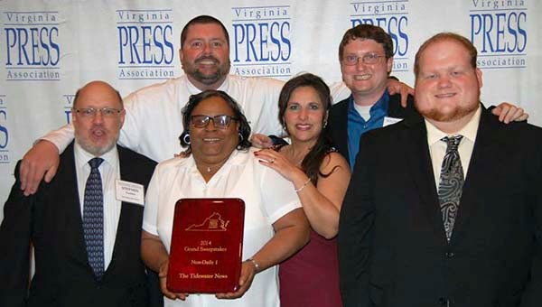 The staff of The Tidewater News with its advertising and news awards. From left, staff writer Stephen Cowles, publisher Tony Clark, graphic designer Loretta Lomax, advertising director Mitzi Lusk, managing editor Cain Madden and graphic designer Ryan Outlaw. -- COURTESY
