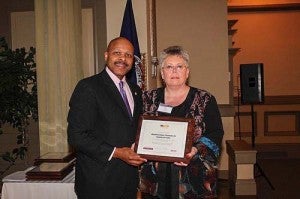 Secretary of Commerce and Trade Maurice Jones presents Kathy Worrell, Downtown Franklin Board Secretary, with Virginia Main Street Milestone award for 55,000 Volunteer Hours. -- SUBMITTED