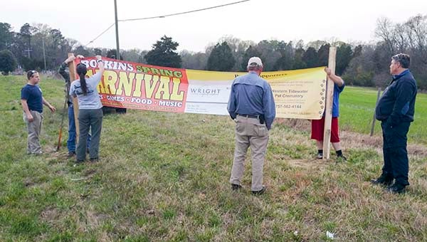 Members of the Boykins Volunteer Fire Department set up a sponsored sign heading into the town. The Boykins Spring Carnival will take place on Friday and Saturday. -- SUBMITTED
