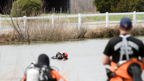 Members of Norfolk Police Department’s 12-person search team signal back to shore. They are searching a retention pond off of Walters Highway (Route 258) for missing 18-year-old Anjelica Hadsell. -- Cain Madden | Tidewater News