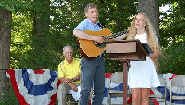 George Atkins and his daughter, Jessica Atkins, provide music for the Memorial Day service. Ivor Vice Mayor Tommy Pittman is seated in the background. -- Merle Monahan | The Tidewater News