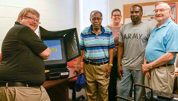 This past week volunteers and professionals gathered in Franklin for the final testing, certifying and sealing of the voting equipment for the June 9 Republican Party Primary Election. From left to right, Jay Overbey of Atlantic Election Services and Franklin Printing Co., Anthony King, the vice chairman of the Franklin Electoral Board, Registrar Jennifer Maynard, Democratic Party Chair Ricky Sykes and Horace Pierce, Franklin’s Electoral Board chairman. -- SUBMITTED