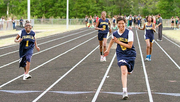 Oceanna Chesson, part of the Champions Together 50-yard dash at Franklin High School, smiles as she leads the group. Others pictured, from left, Tanashia Brown, Rosemary Idisi and Ladesia Mitchell. -- Cain Madden | Tidewater News