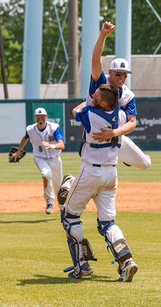 Seniors Matt Rose and Brynner Porter, fist raised, celebrate as coaches and teammates run to the pitcher’s mound after the final out was recorded. Porter completed the game, as Southampton Academy won its second State Championship. -- Cain Madden | Tidewater News
