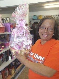 Portia Everett of Unique Unlimited holds up a gift basket that she prepared. Her business on 600 South St., in Franklin specializes in such handmade creations. -- Stephen H. Cowles | Tidewater News