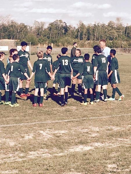 The Rock Church School Lions pray before their first home match with Southampton Academy.