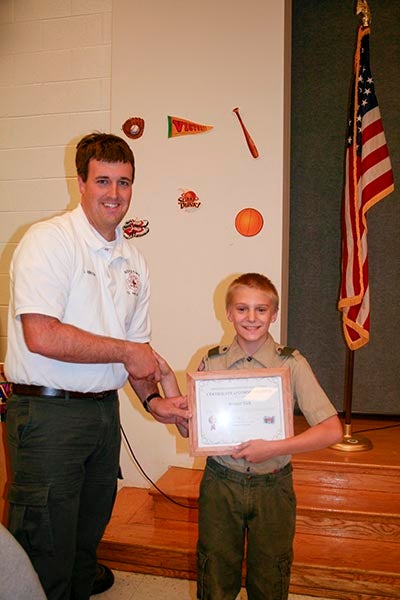 Newsoms Volunteer Fire Chief Jonathan Hinson presented fifth-grader Robert Vick with a certificate of commendation.