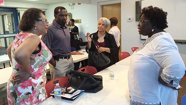 Discussing plans for the next education session on the Affordable Health Care Act are, from left, Del. Roslyn Tyler (D-75), local Democratic Party Chair Ricky Sykes, local business owner Yvonne Rose, and certified navigator for Enroll Virginia Elise Brown.