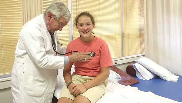 Dr. Daniel Peak begins examining Southampton High student Megan Purvis as part of a free sports physical program. She plays softball and basketball for the school. -- Walter Francis | Tidewater News