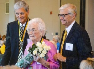 Earl Young, chairman of the Olde Guarde Council for The College of William & Mary, left, and College President Taylor Reveley escort Mildred Doughty of Franklin in honor of her 80th reunion from the university in Williamsburg in 2012. -- FILE PHOTO