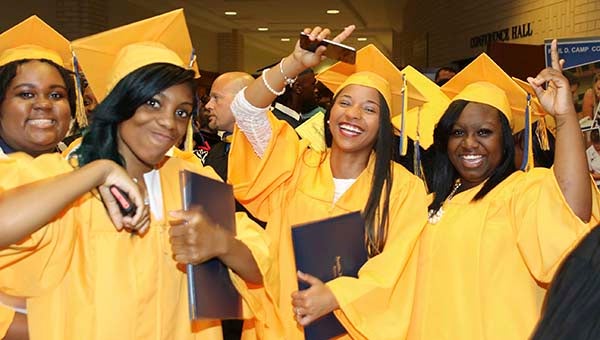 From left, Kei-Airra King, Kyndal Hall and Alexus Harris celebrate after the Franklin High School graduation on Friday night. -- Frank Davis | Tidewater News