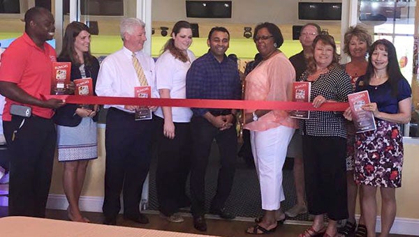 Members of the Franklin-Southampton Chamber of Commerce, along with city management, the mayor and staff of Rumors cut the ribbon at the grand reopening of the restaurant and lounge at the Franklin Bowling Center. -- SUBMITTED