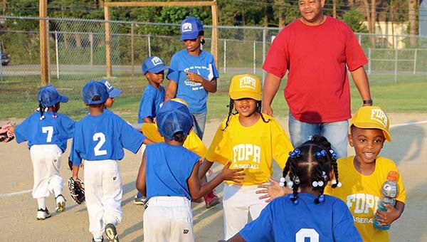 The Yellow and Blue T-ball teams shake hands after a contest at Armory Field. -- Frank Davis | Tidewater News