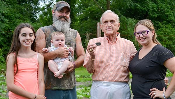 The Lilly family together stands in front of the garden where the tag was found.  From left to right, Madison, Dayla, Kelby and Allison  with Wesley Wills. -- Mitzi Lusk | Tidewater News