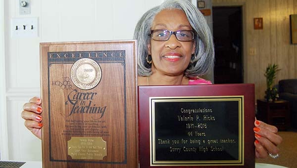 merle monahan | The Tidewater news Valerie P. Ricks holds up two of four plaques she received recognizing her outstanding teacher abilities, longevity.