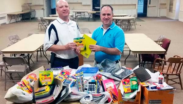 Travis Felts, coordinator of Pupil Personnel, Testing and Instruction accepts the generous donation of school supplies from the Rev. Brent Kimlick, senior pastor at Franklin Baptist Church. -- SUBMITTED