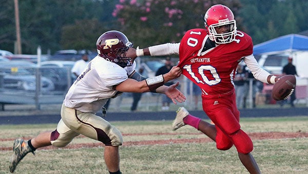 Southampton junior quarterback Andrew “A.J.” Blunt is corralled by a Poquoson defensive lineman in the opening quarter of Friday’s contest. The Islanders blanked the Indians, 42-0, on the way to their ninth-consecutive victory in the series. -- Frank Davis | Tidewater News