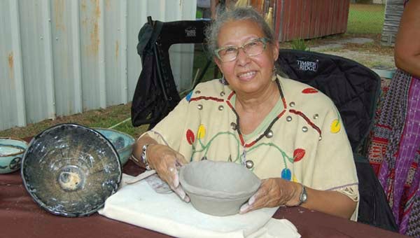 Nottoway Chief Lynette Allston showing off a bowl she had just crafted at Heritage Day. -- MERLE MONAHAN | The Tidewater news