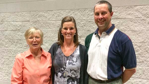 Trevor Snyder’s parents, Renita and Matt, picked up a scholarship on his behalf during the local Farm Bureau’s annual dinner meeting. Gail Phillips, left, presented a check on behalf of the Women’s Committee. -- Stephen H. Cowles | Tidewater News