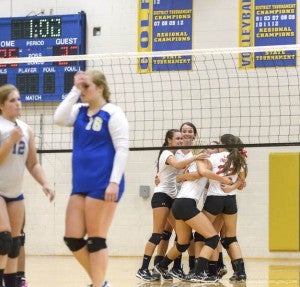 Southampton High varsity volleyball hug each other with excitement over another win. -- Murray Thompson