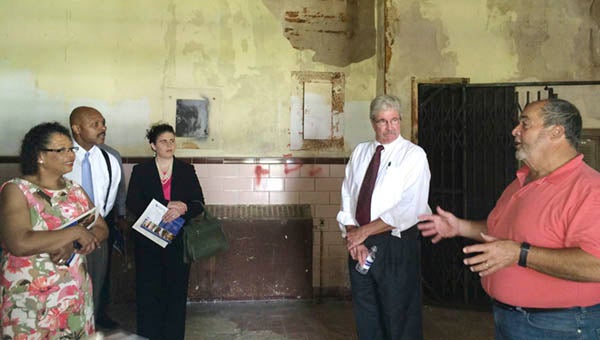 During a tour of the old Hayden High School this past July, Al Hartley, right, tells Del. Roslyn Tyler, Sec. Maurice Jones and Amanda Jarratt of the FSEDI about plans for one of the rooms in the building. John Skirven, CEO of Senior Services, is close by. -- FILE PHOTO