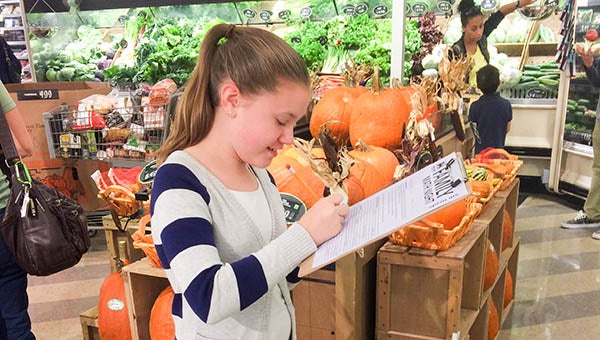 S.P. Morton Elementary School held a “Math Night” at Food Lion on Thursday evening. Students were given worksheets and asked to walk around and answer the questions that were based on the skills they were learning in class. Pictured is Emmy Benton. -- Rebecca Chappell | Tidewater News