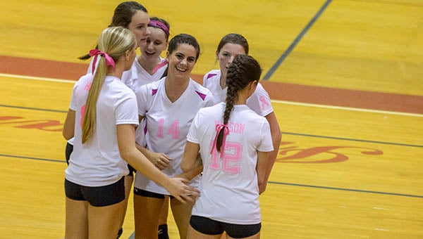 Southampton High varsity volleyball players celebrate after defeating Greensville in straight sets on Thursday night. -- Murray Thompson | Tidewater News