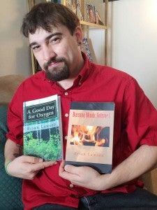 Brian Lawson of Windsor shows the two books he recently published. “A Good Day for Oxygen” is a collection of his poems and haikus. “Burning Minds: Volume I” is his first novel. The lifelong town resident has two other books of poetry, which were published in 2010. -- STEPHEN H. COWLES | The Tidewater news