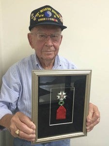 Joe Quentin Dickerson of Murfreesboro, North Carolina shows one of the medals he earned for his service during WWII. -- Stephen Cowles | The Tidewater News
