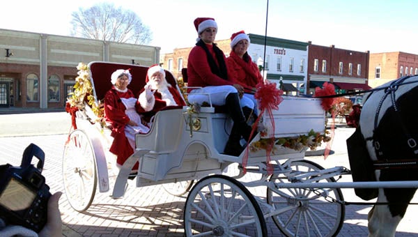 Santa and Mrs. Claus stopped by the Christmas Open House in Downtown Franklin to enjoy a carriage ride together. -- SUBMITTED