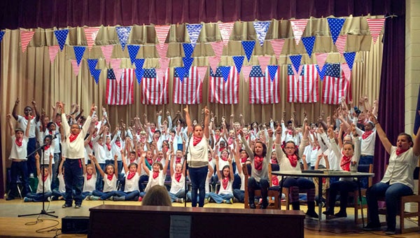 The fourth-graders sing a medley of patriotic songs during their tribute to veterans. -- Stephen Cowles | Tidewater News