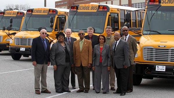 Members of the school board and board of supervisors were on hand for Southampton’s school bus unveiling. From left, William Worsham, Superintendent Dr. Alvera J. Parrish, Supervisor Barry Porter, Chairman Dallas Jones, Vice Chairman Ronald West, Florence Reynolds, Supervisor Bruce Phillips, Wayne Smith and Director of Auxiliary Services and Transportation Ricky Blunt. -- Andrew Lind | Tidewater News