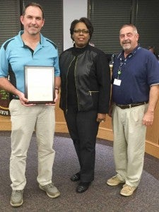 George Donnie Cagle Jr., left, was recognized for his retirement from the City of Franklin during Monday night’s City Council meeting. Also pictured are Mayor Raystine Johnson-Ashburn and Director of Public Works Russ Pace. -- SUBMITTED