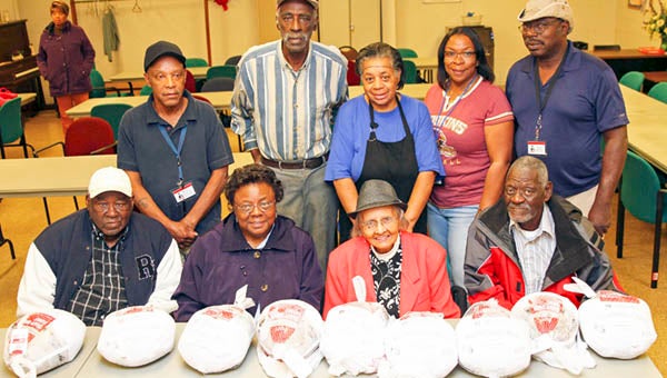 Some of the people who received the LEVOC turkeys pose at the Martin Luther King Jr. Center in Franklin. In front, from left, are seniors Bobby Brown, Virginia Edmonds, Hattie Holland and Burnart Hargrove; back, LEVOC staff member Gerald Handy, senior member Henry Warren, food services staff member Roxie Warren, senior site director Darlene Brown, and staff member Buddy Holloway. -- Frank Davis | Tidewater News