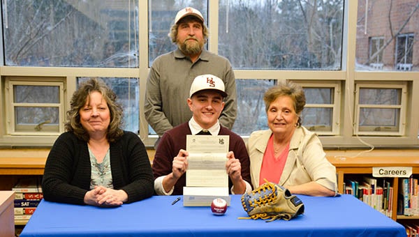 Cory Childress holds up holds up his signed letter of intent to play baseball for Hampden-Sydney College. With him are his parents and his grandmother. -- SUBMITTED