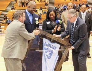 Nate McMillan (second from left) is presented his retired #23 jersey from Chowan University President Dr. Chris White (right) and Athletic Director Ozzie McFarland (left). Also pictured is McMillan’s wife, Michelle. -- CAL BRYANT | ROANOKE-CHOWAN NEWS-HERALD