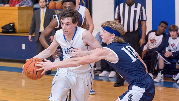 Senior guard Jackson Smith drives to the basket in Friday’s win over Blessed Sacrament-Huguenot. -- MURRAY THOMPSON | The Tidewater news