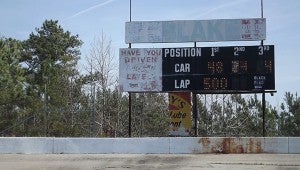 Faded signs are all that remain of the race track’s sponsorship. -- Andrew Lind | Tidewater News