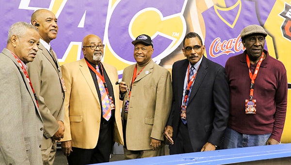 Larry “Chuck” Rose, in black hat, poses for pictures with his MEAC officiating crew. -- Frank Davis | Tidewater News
