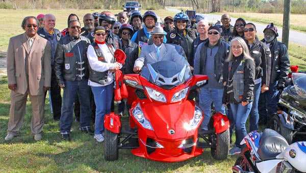 After the service, the Rev. Dr. “JJ” Ferguson (center sitting on red motorcycle) spent some time talking with the bikers on the church grounds and posed with the group before they departed for the ride home.  -- Frank Davis | Tidewater News