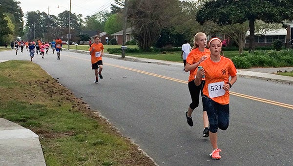 Middle school students in Isle of Wight County return from the halfway mark of the Blue ‘n’ Gray 5K, which took place last Friday starting at the Windsor High School track. -- Stephen H. Cowles | Tidewater News