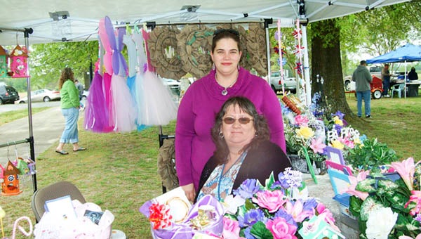 Teresa Bolen, seated,  andThea Green of Suffolk sell flowers they make as a hobby. They were among the many vendors at the Day in the Country in 2015. This year, the event takes place on Saturday, April 23 from 10 a.m. to 3 p.m. -- FILE PHOTO
