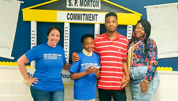 La’Desha Warren, a student at S.P. Morton Elementary School, won the 2016 Child Abuse Prevention T-Shirt Contest. Pictured are Jill Gorgei (Franklin City Department of Social Services), La’Desha Warren, Earl Warren Jr. (Father) and Lakitia Warren (Mother).