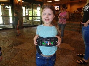 Chloe Jarratt displays the fanny pack that holds the technology which functions as an artificial pancreas.