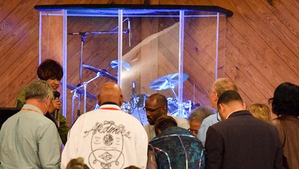 Local churches came together on Thursday evening to participate in National Day of Prayer. Pictured are Dr. Peggy Scott and members of the clergy from local churches praying together. -- Rebecca Chappell | Tidewater News
