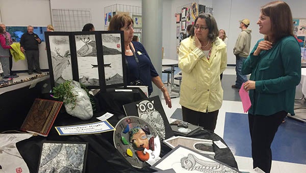Windsor High School Art Teacher Lois West, left, talks with Sharon Harrell and Rebecca Cox, both of Carrsville. An Asian style was prominent in the artwork by many of West’s students. -- Stephen H. Cowles | Tidewater News
